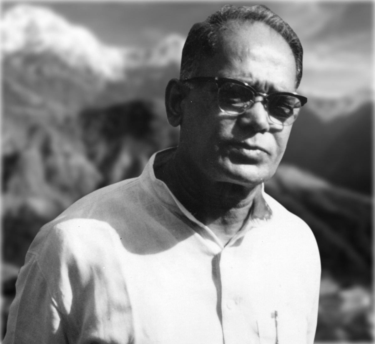 Studio portrait of Jaya Prakash Narayan in a white kurta against a painted mountain backdrop